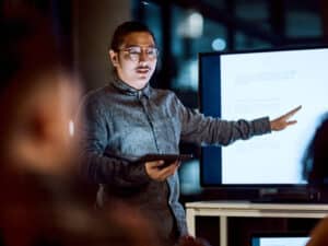 Shot of a young businessman delivering a presentation during a late night meeting at work