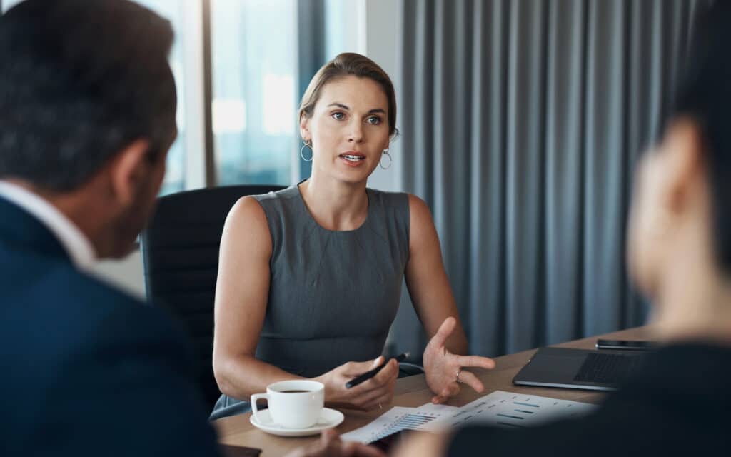 A business meeting in a grey toned corporate setting