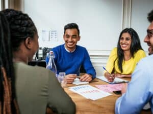 A group of people smiling in a meeting