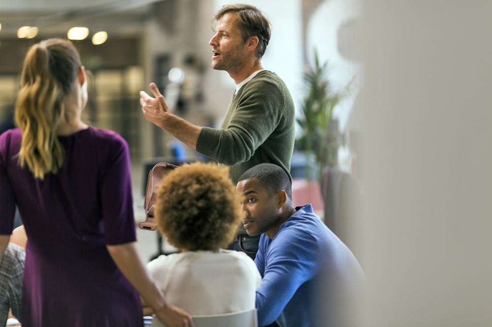 Businessman talking to colleagues in meeting