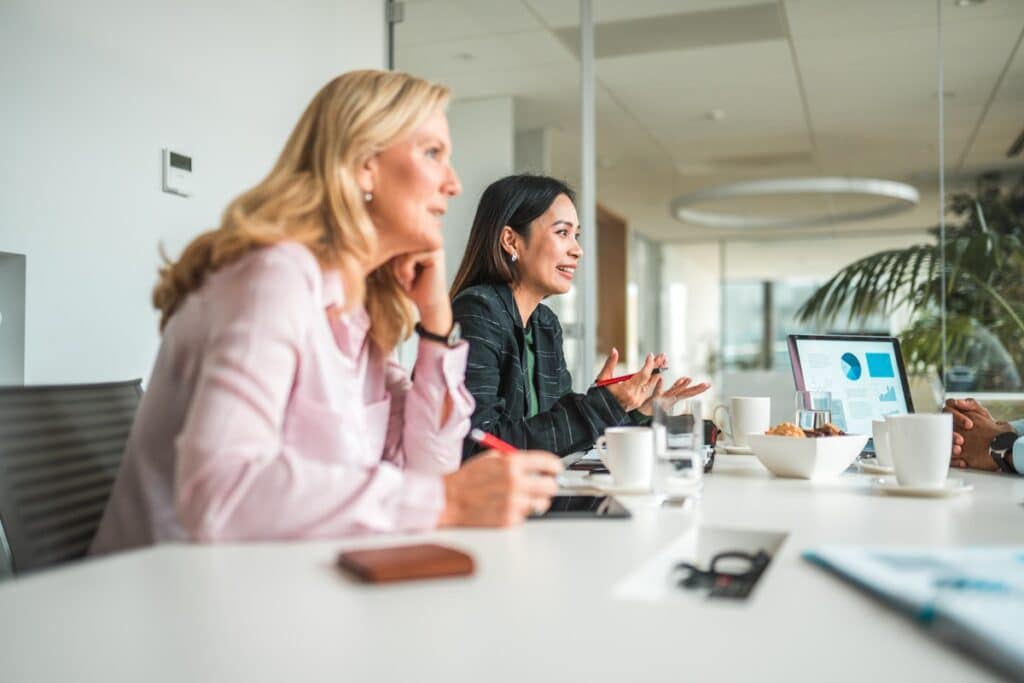 Professional women Instructing the Team at Meeting Table