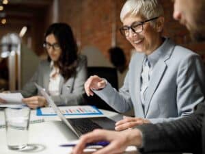 Smiley person engaged with others around office