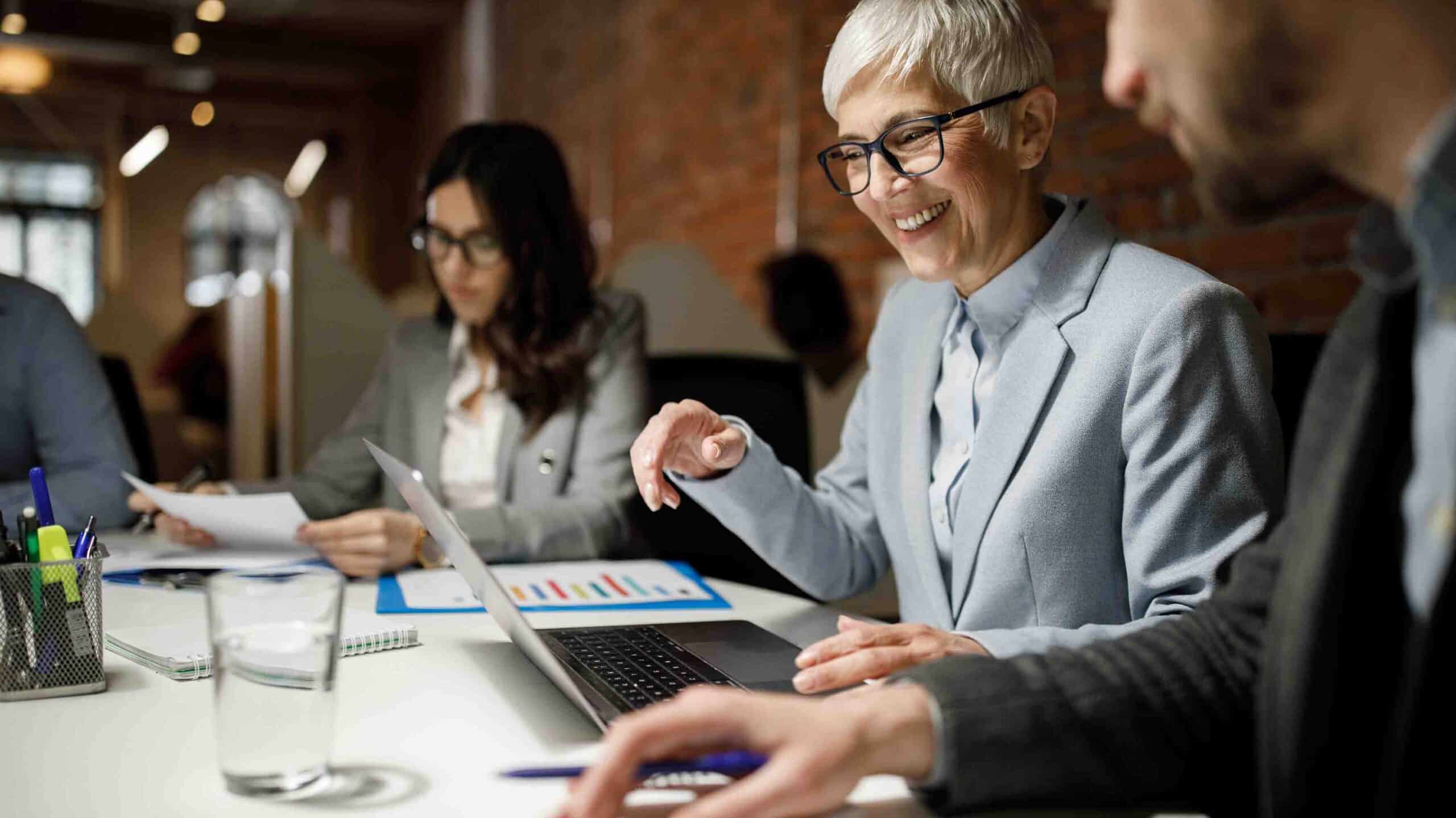 Smiley person engaged with others around office
