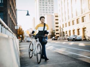 Young Woman With Bike and Messenger Bag in The City