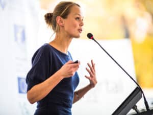 business woman giving a presentation in a conference/meeting setting (shallow DOF; color toned image)