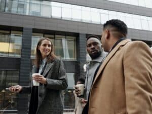 Professionals walking and talking with coffee