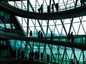Abstract modern architecture and silhouettes of people on spiral staircase
