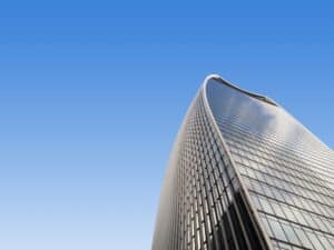 Top of skyscraper against blue sky