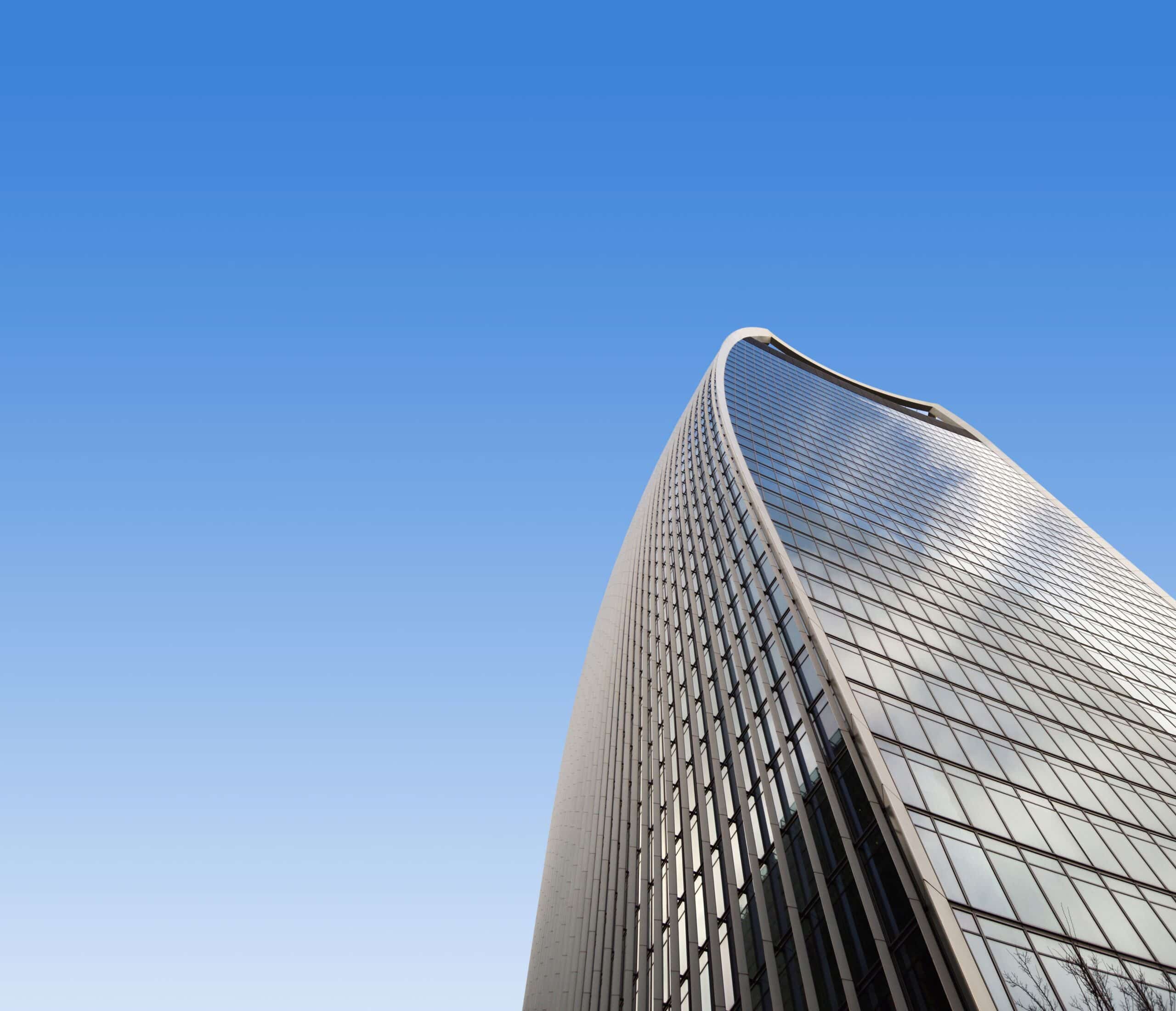 Top of skyscraper against blue sky