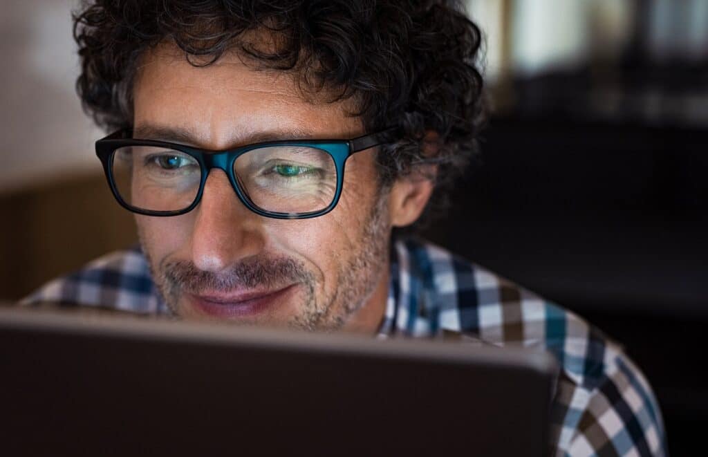 Detailed close up of man using laptop