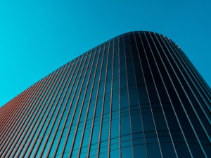 Image taken of a glass building, shown from the bottom, looking upwards, showing only a portion of great significance.