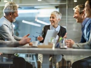 Group sharing ideas around a boardroom table