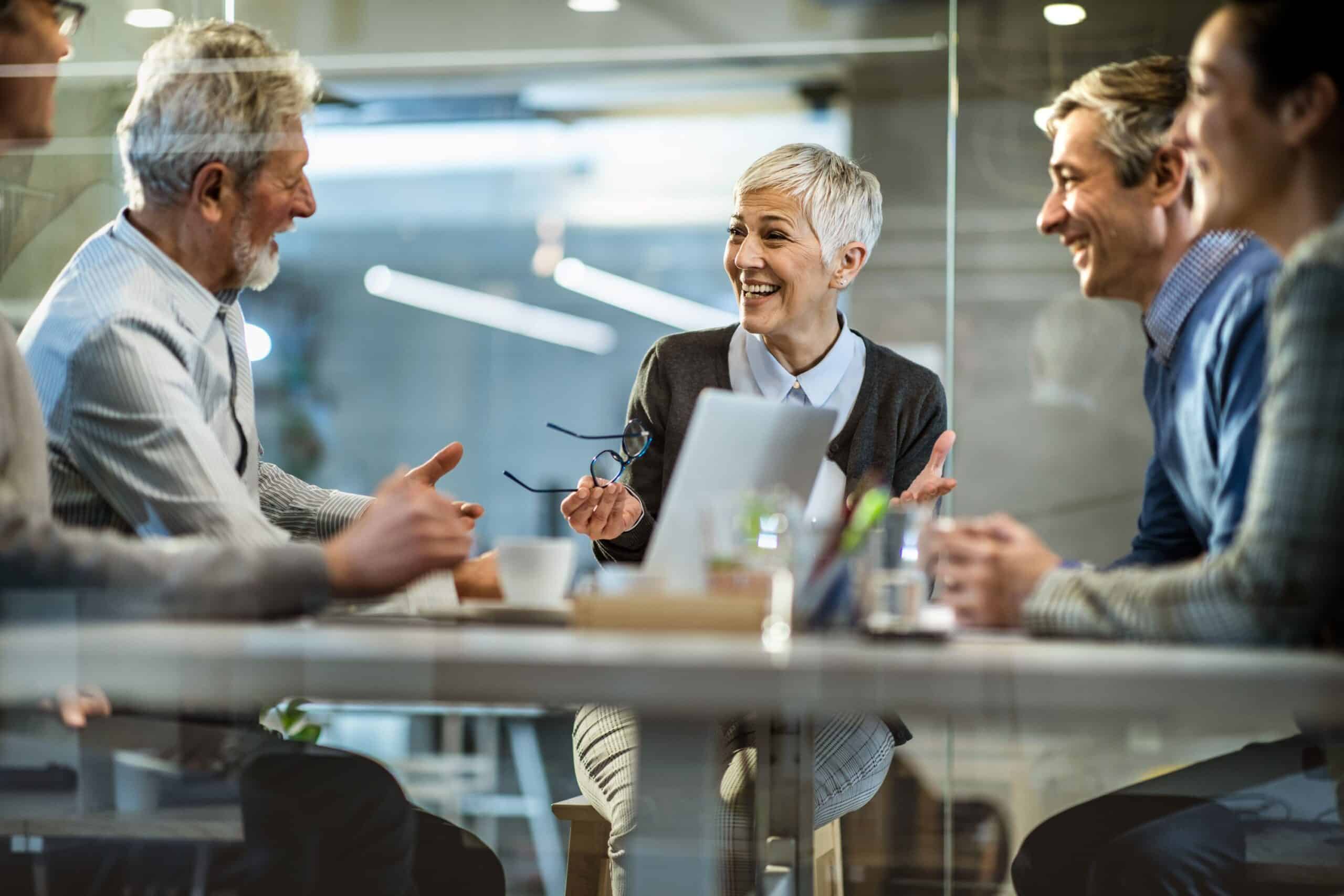 Group sharing ideas around a boardroom table