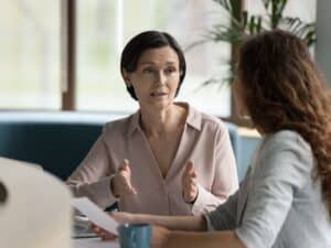 Two women sit for a meeting