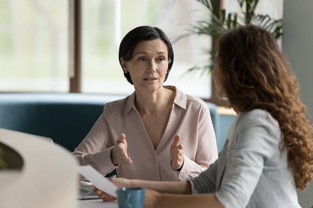 Two women sit for a meeting