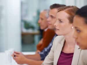 A group of business people listening to a presentation at a seminar