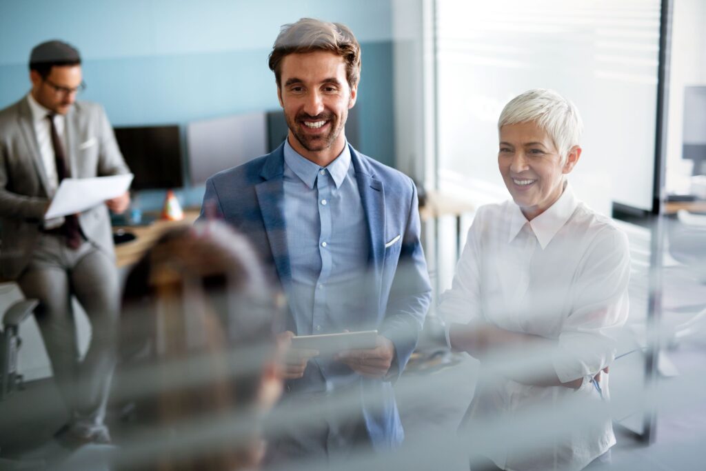 A smiling group of people in a meeting