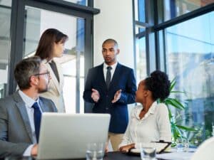 Leader leading group discussion around table