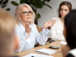 Professionals meet in person in an office