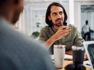 Cropped shot of a businessman sitting with his colleagues in the office