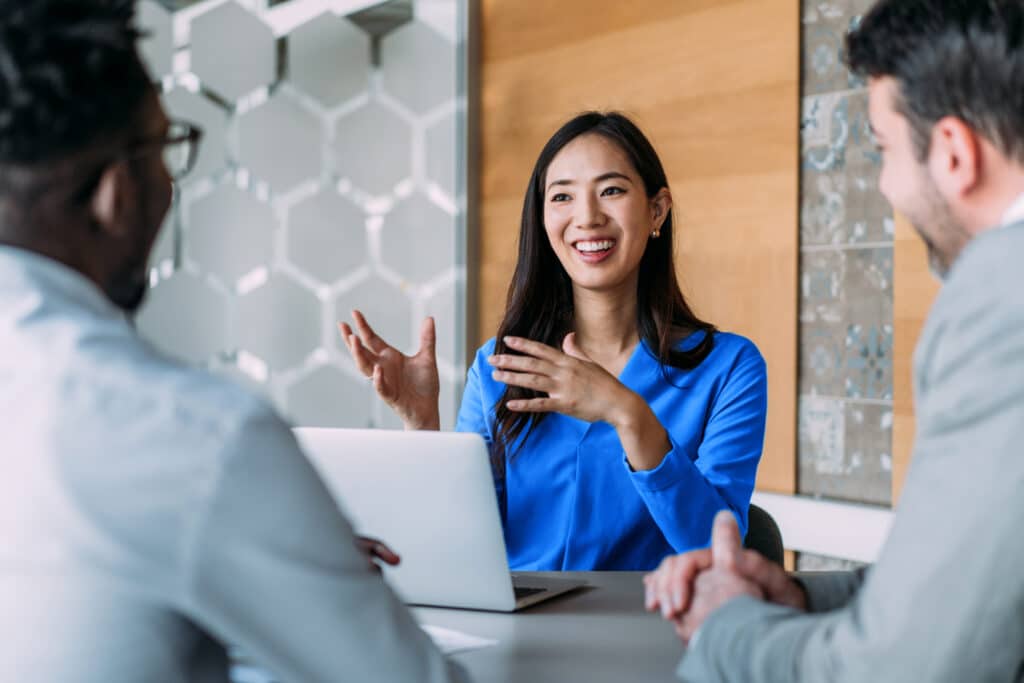 Shot of group of business persons in business meeting. Three entrepreneurs on meeting in board room. Creative business team on meeting in modern office. Female manager discussing new project with her colleagues. Company owner on a meeting with two of her employees in her office.
