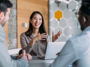 Group of business persons talking in the office.