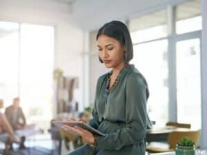 Shot of a young businesswoman using a digital tablet in a modern office